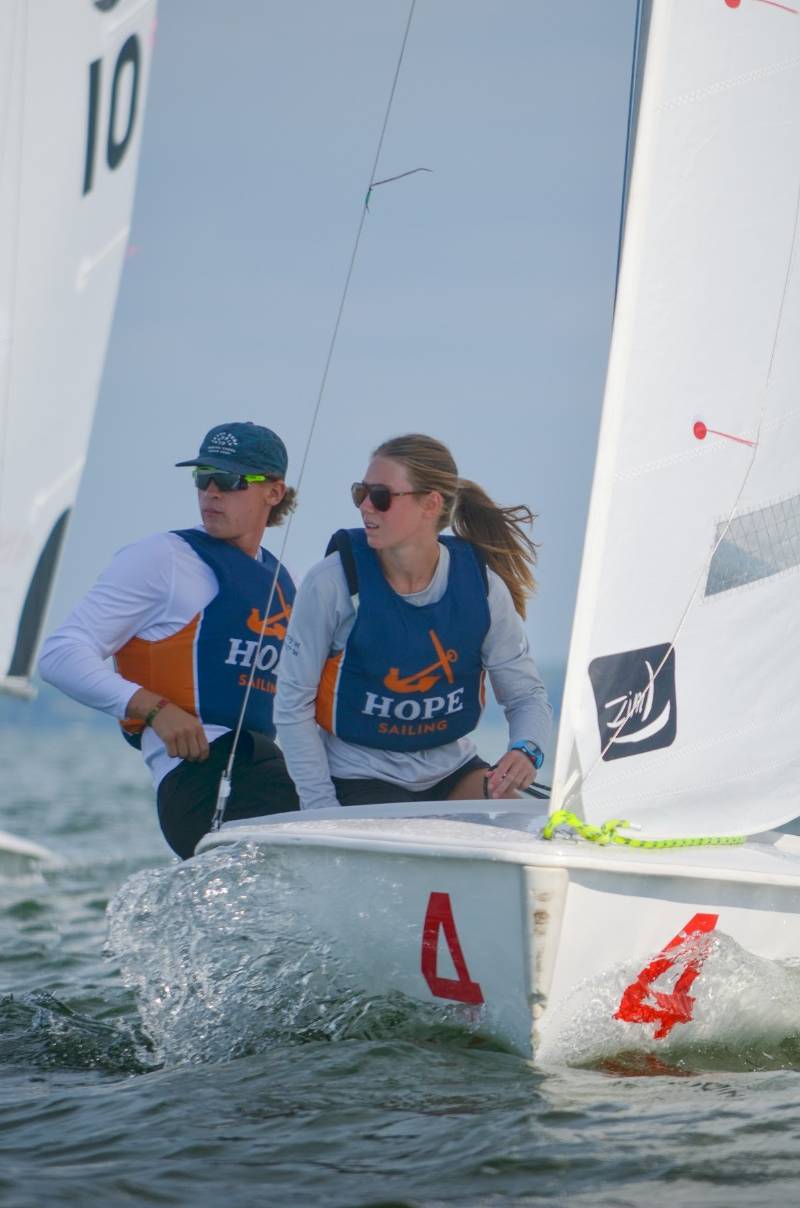 Two Sailing Club members on a sailboat.