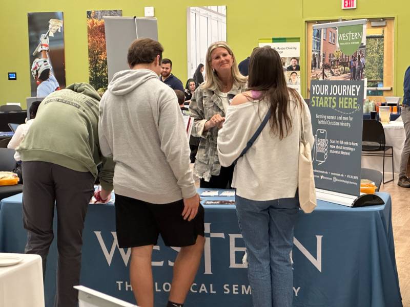 Ministry and Christian Grad School Fair Students leaning on table Ministry and Christian Grad School Fair