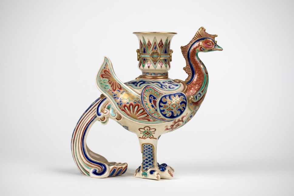 "Pheonix Vase" by Makuzu Kozan An ornate white vase in the shape of a bird with colored details