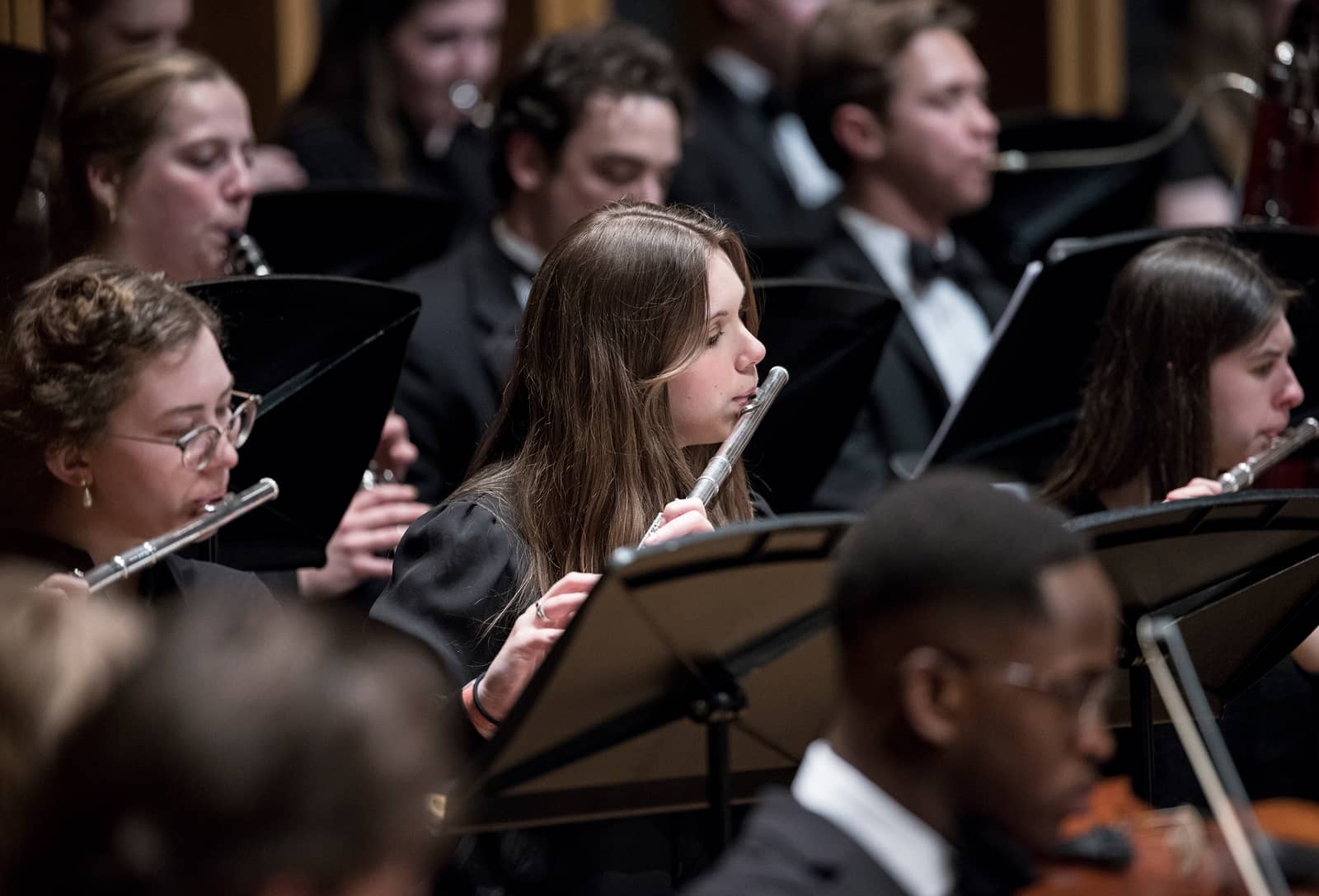 Closeup image of a female flautist in the Hope College Orchestra