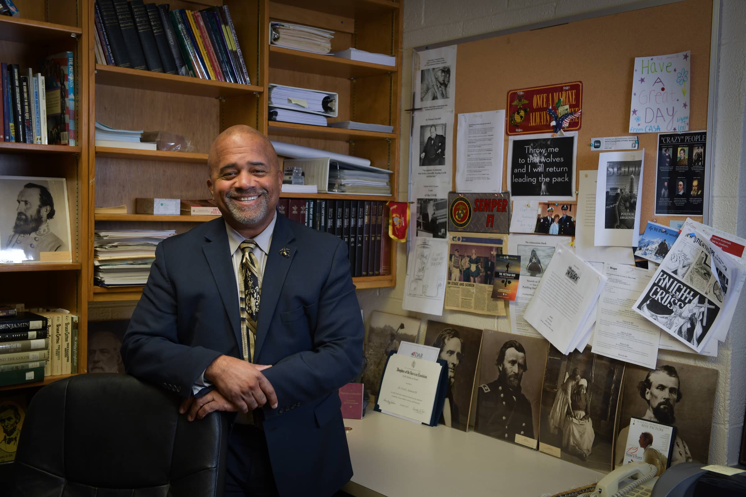 Dr. Fred Johnson standing in his office and smiling at the camera